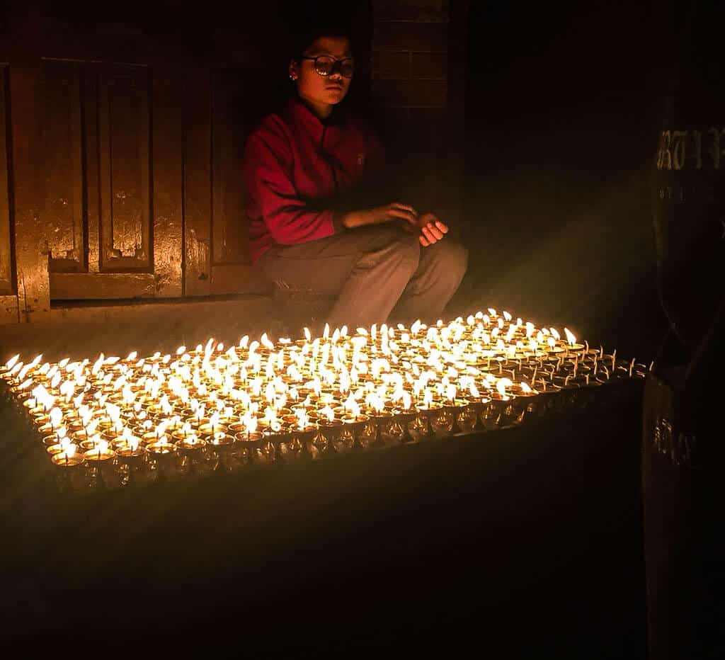 A butter lamp seller at Boudha Stupa