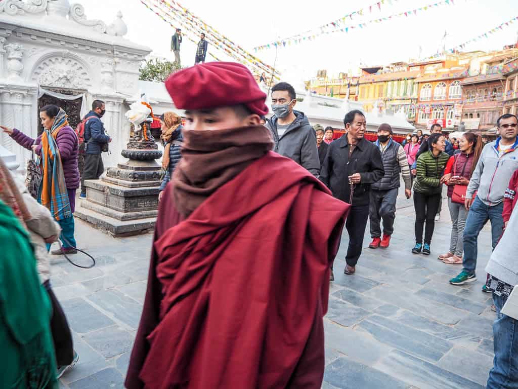 A Tibetan Monk walking around Boudha Stupa